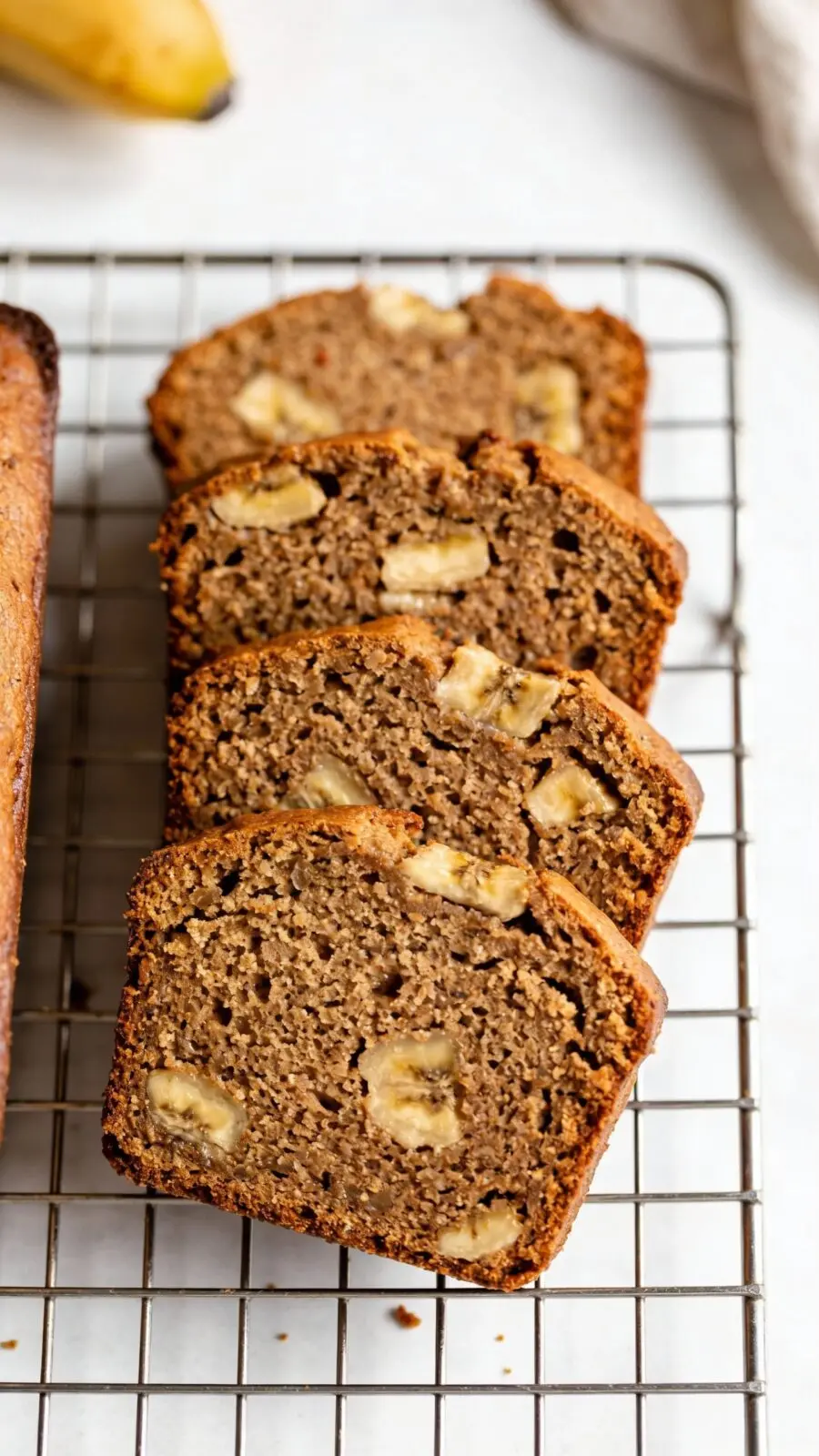 Sliced low-sugar banana bread on cooling rack