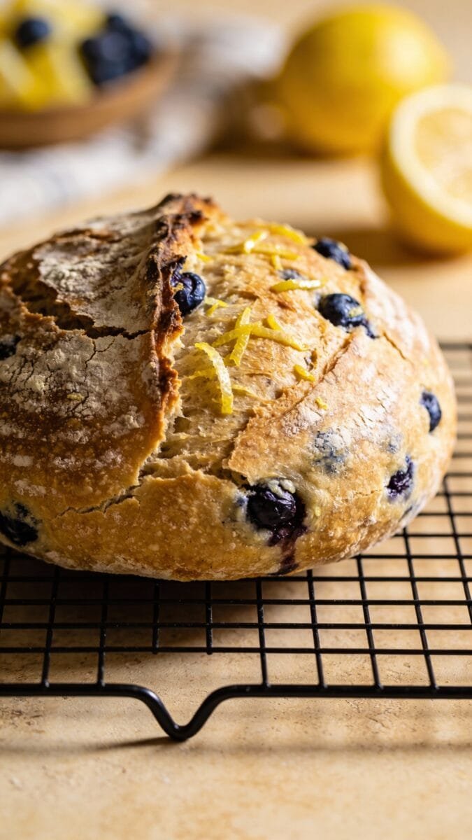 lemon blueberry sourdough loaf on cooling rack