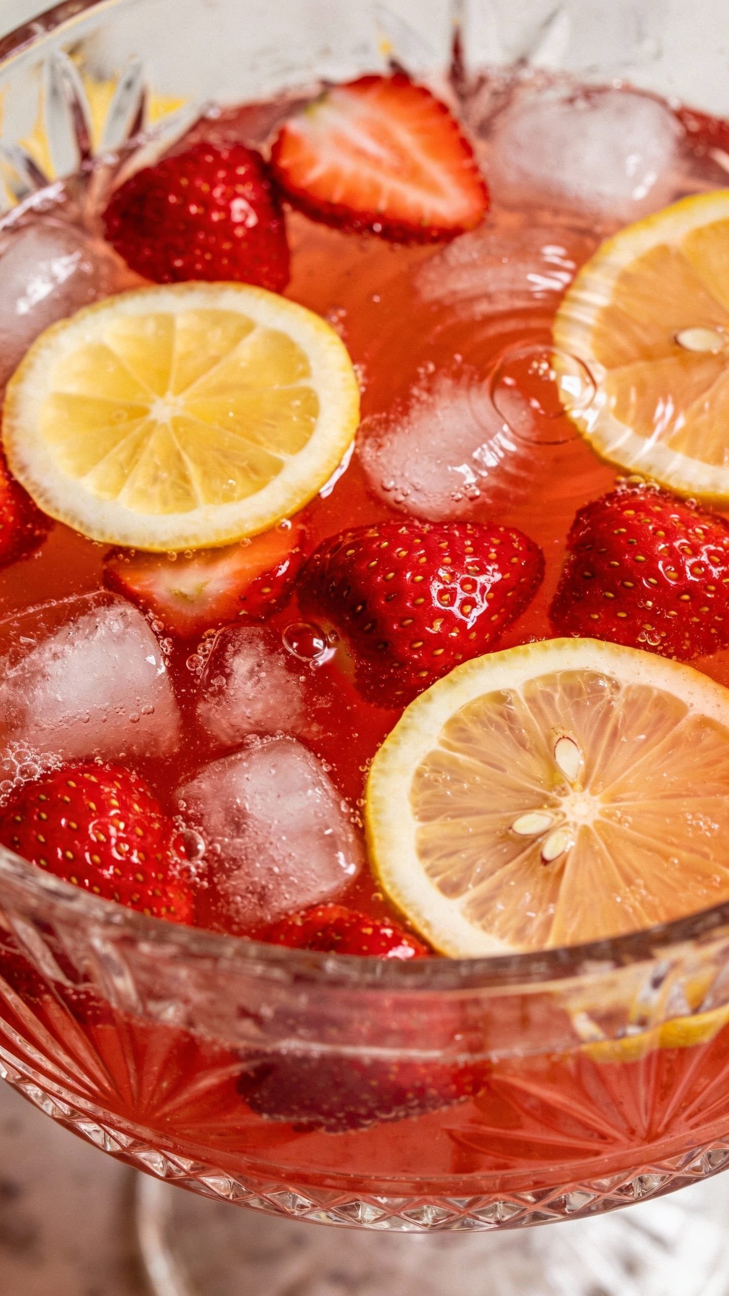 Strawberry punch bowl with lemonade and ice, overhead