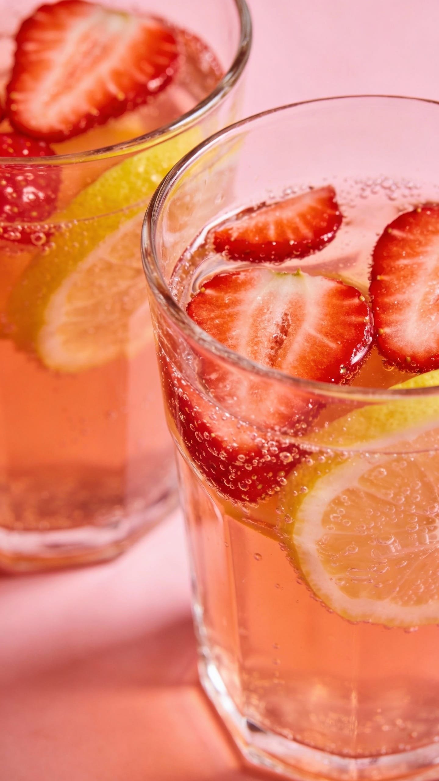 Clear glasses of strawberry lemonade punch with bubbles